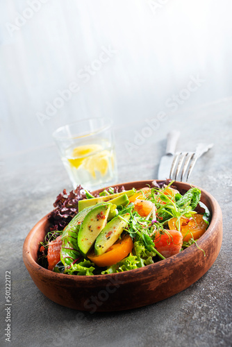 Salad with avocado, tomatoes and fresh greens