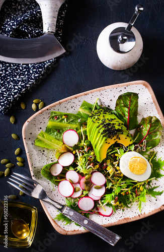 fresh salad, salad with avocado and boiled eggs photo