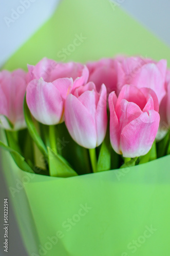 Fototapeta Naklejka Na Ścianę i Meble -  Tulips flowers bouquet with pink tulips in green paper