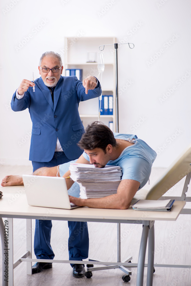 Young male employee feeling bad at workplace Young male employee feeling bad at workplace