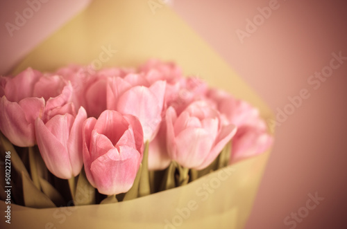Tulips flowers bouquet with pink tulips in green paper