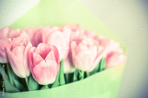 Tulips flowers bouquet with pink tulips in green paper
