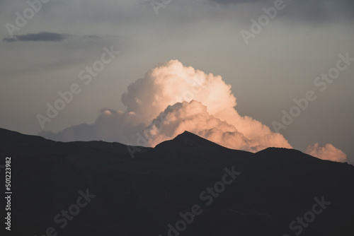 especially grained cloud and mountain silhouette