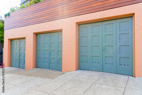 Photography Three side-hinged garage doors with gold door handles at San Francisco, Californ