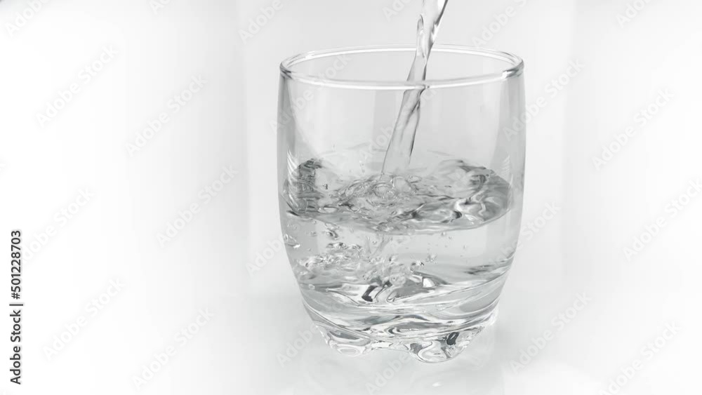 Pure Water Poured Into Glass isolated on white Pure Water Poured Into Glass isolated on white