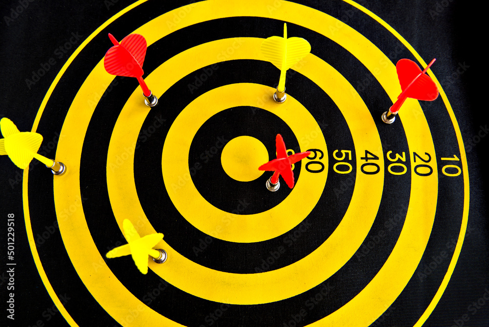 Darts game, yellow and black dartboard with sticky darts. Darts game, yellow and black dartboard with sticky darts.