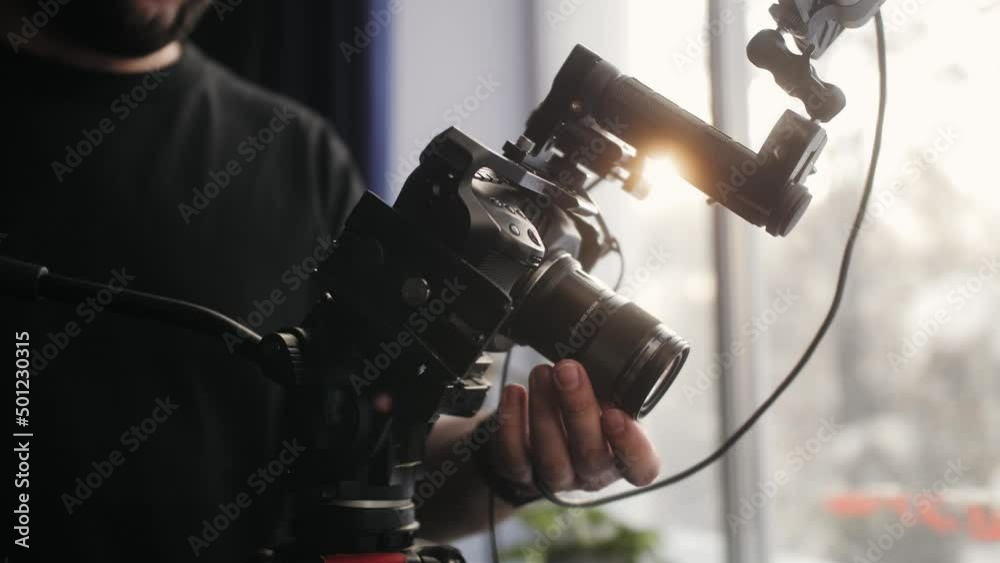 Video production backstage. Professional camera man creating video content in studio, commercial filming.