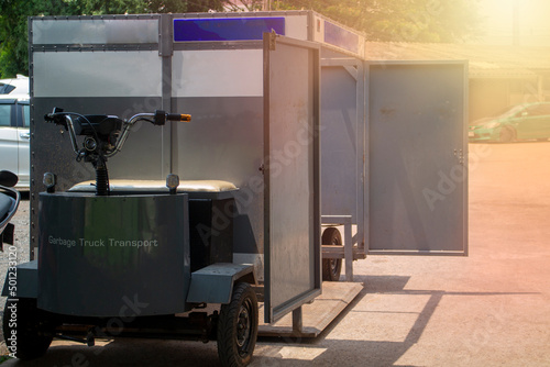 The electric garbage truck  inside the hospital is used for transporting dangerous infectious waste bins.