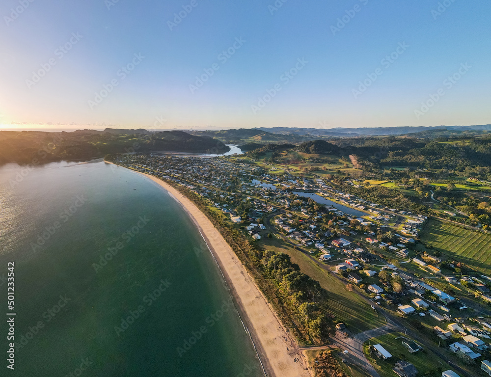 Sunrise over Cooks Beach coastline along the Coromandel Peninsula in New Zealand's North Island.