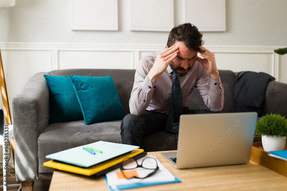 Exhausted man trying to solve work problems Exhausted man trying to solve work problems