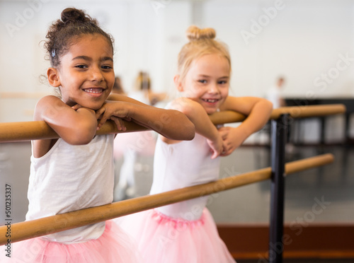 Two little girls practicing ballet elements and positions in dance studio Fototapet