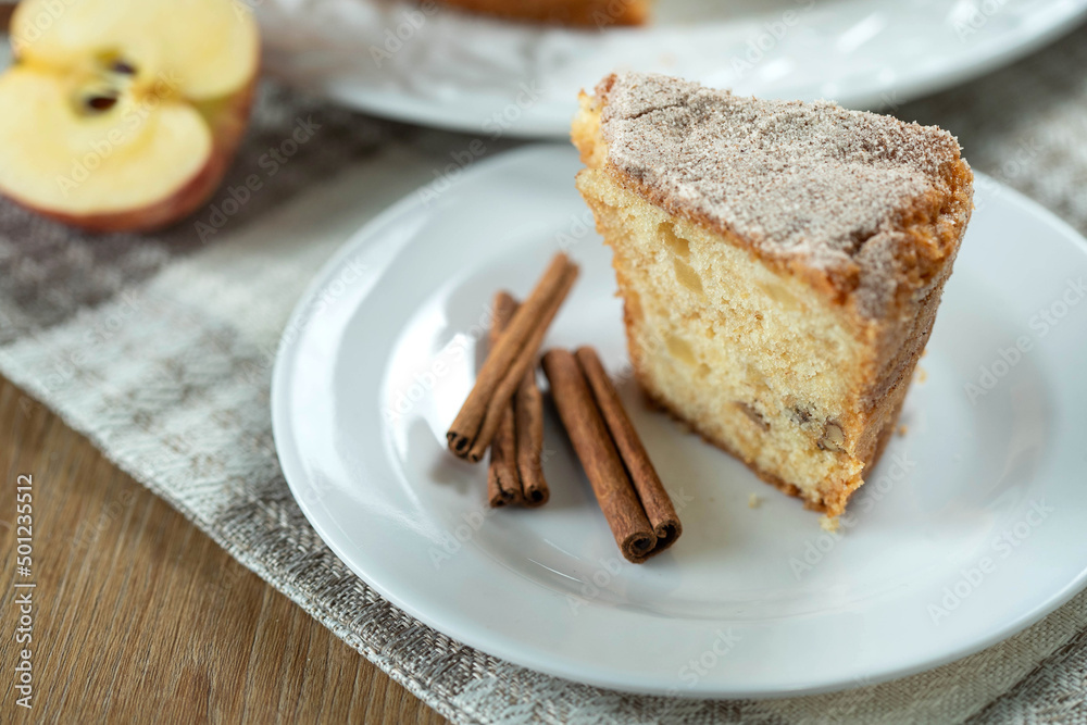 piece of Sponge cake or chiffon cake with apples so soft and delicious sliced with ingredients: cinnamon, eggs, flour, apples on wooden table. Home bakery concept for background and wallpaper piece of Sponge cake or chiffon cake with apples so soft and delicious sliced with ingredients: cinnamon, eggs, flour, apples on wooden table. Home bakery concept for background and wallpaper