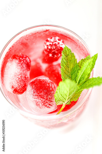 Raspberry cocktail.Summer drink.raspberry pink drink.Ice cubes with raspberries in a glass with mineral water, berries and raspberry leaves. refreshing cocktail. 