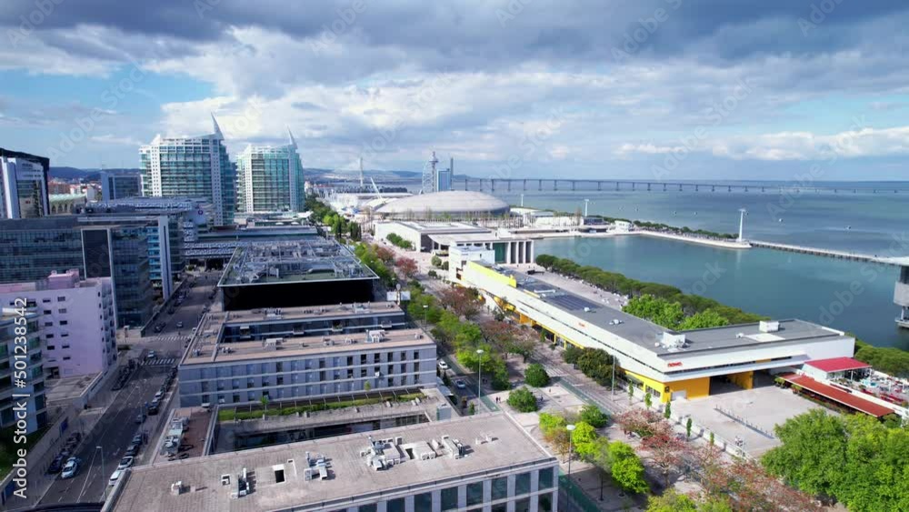 Lisbon, Portugal, April 24, 2022: DRONE AERIAL FOOTAGE: The Parque das Nacoes (Park of Nations), is a neighborhood in Lisbon constructed for the 1998 Lisbon World Exposition.