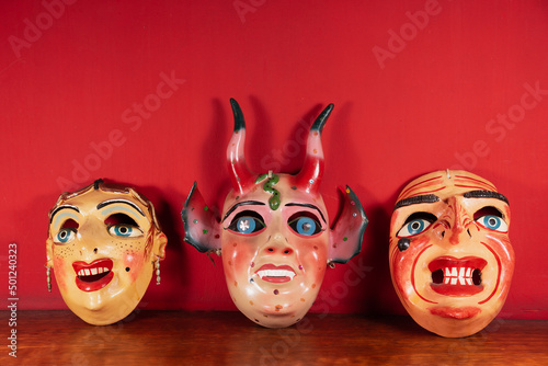 Máscaras típicas de Cuzco - Perú con fondo rojo photo