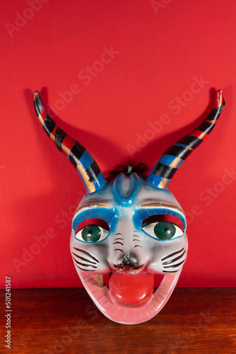 Máscara típica de Cuzco - Perú con fondo rojo photo