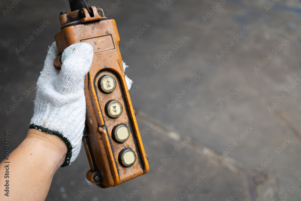 Industrial control buttons. hand holding overhead cranes remote. Up ...