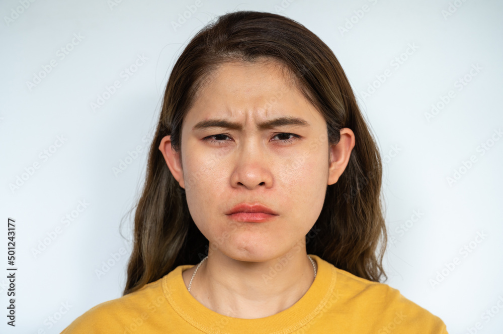 Portrait of young Asian woman having negative emotions. Negative emotions are unpleasant and disruptive emotional reactions. Portrait of young Asian woman having negative emotions. Negative emotions are unpleasant and disruptive emotional reactions.
