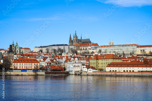 Cityscape of east europe with summer nature. Old church near the river with blue sky on the background.