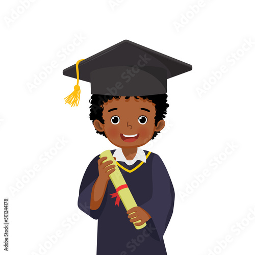 cute little African schoolboy in graduation hat and gown holding diploma certificate