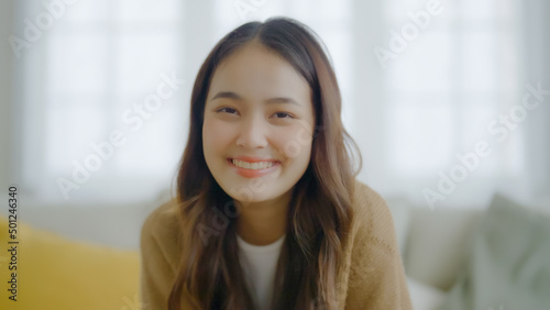 Portrait smiling asian young woman looking to camera. Facial expression happy