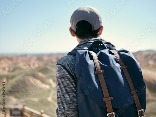 rear view of male asian tourist backpacker looking at view in national park © imtmphoto