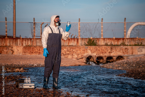 Cuadro en lienzo Scientist wearing protective uniform and glove under working water analysis and water quality by get fishes dead to check effected case in laboratory is environment pollution problem concept
