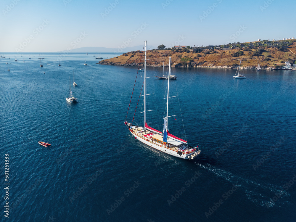 Aerial view of a white yacht crossing Bodrum Harbor, Turkey