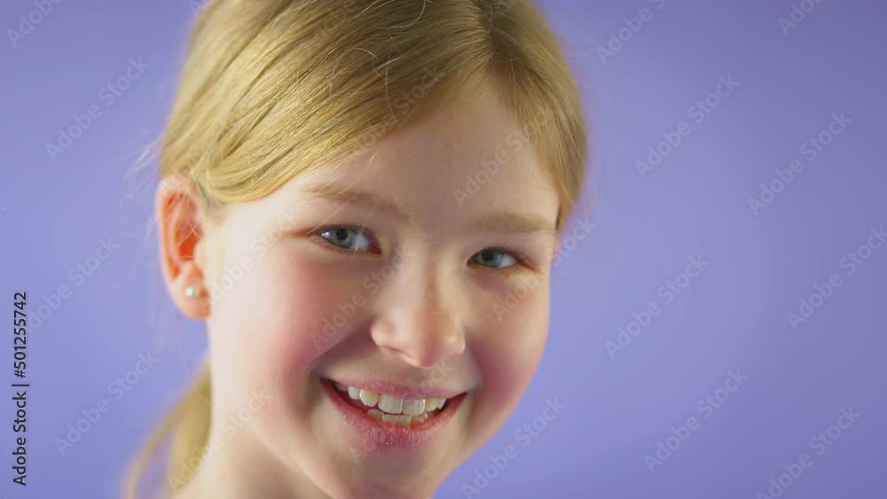Studio Portrait Of Smiling Girl With Long Hair Against Purple Background Studio Portrait Of Smiling Girl With Long Hair Against Purple Background