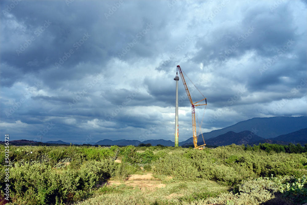 Landscape with construction site of wind turbine towers. Industrial concept for sustainable growth and reduce climate change and global warming
