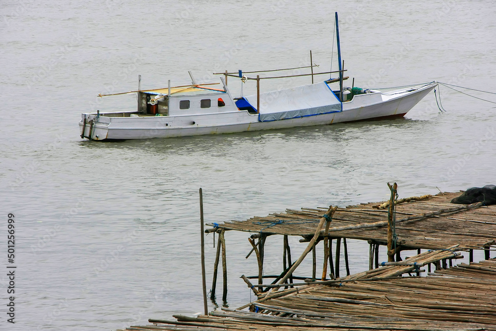 Traditional boat anchored at Labuan Bajo town on Flores Island, Nusa Tenggara, Indonesia Traditional boat anchored at Labuan Bajo town on Flores Island, Nusa Tenggara, Indonesia