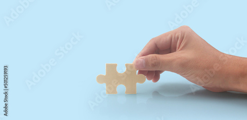 Connecting jigsaw puzzle in hand