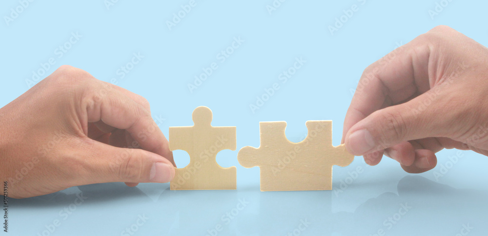 Connecting jigsaw puzzle in hand Connecting jigsaw puzzle in hand