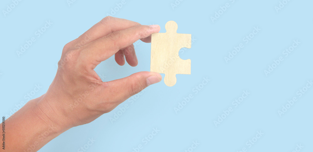 Connecting jigsaw puzzle in hand Connecting jigsaw puzzle in hand