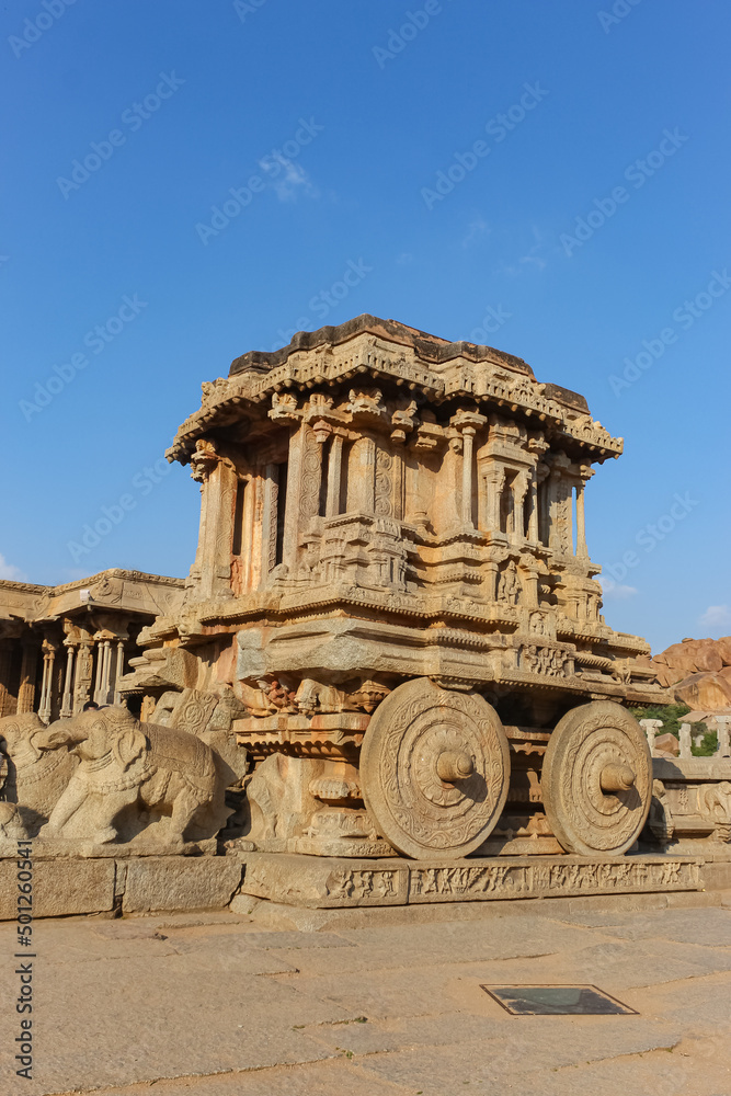 hampi stone chariot the antique stone art piece from unique angle with amazing blue sky image is taken at hampi karnataka india. it is the most impressive and truly splendid architecture in hampi.