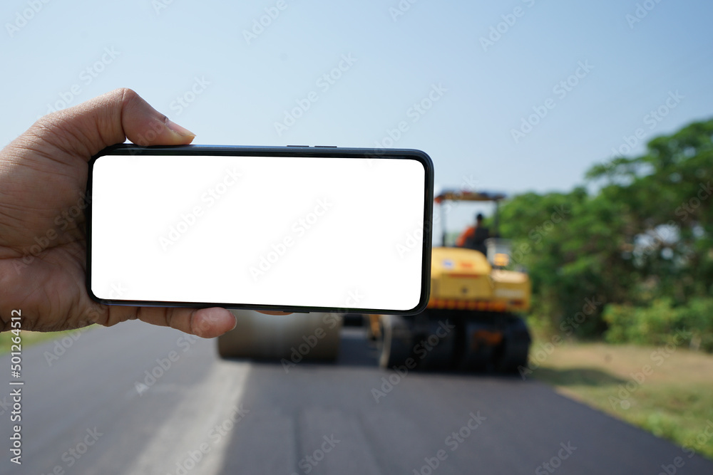 Mobile phone and road construction blur background Mobile phone and road construction blur background