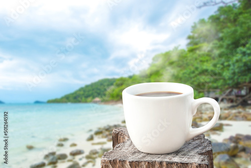 coffee cup over blue sea background.