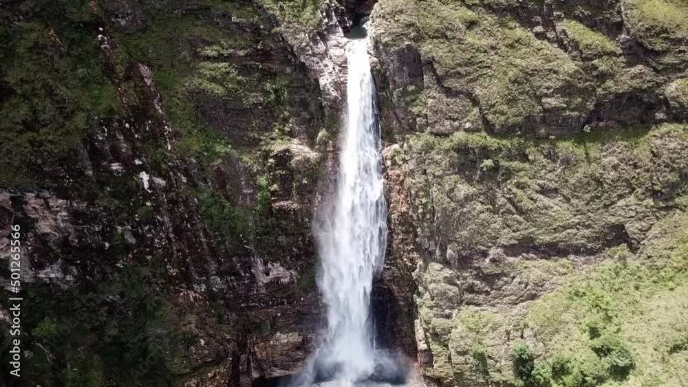 Single Drop Waterfall Flowing Down The Rocky Cliff In Summer. - aerial tilt down Single Drop Waterfall Flowing Down The Rocky Cliff In Summer. - aerial tilt down