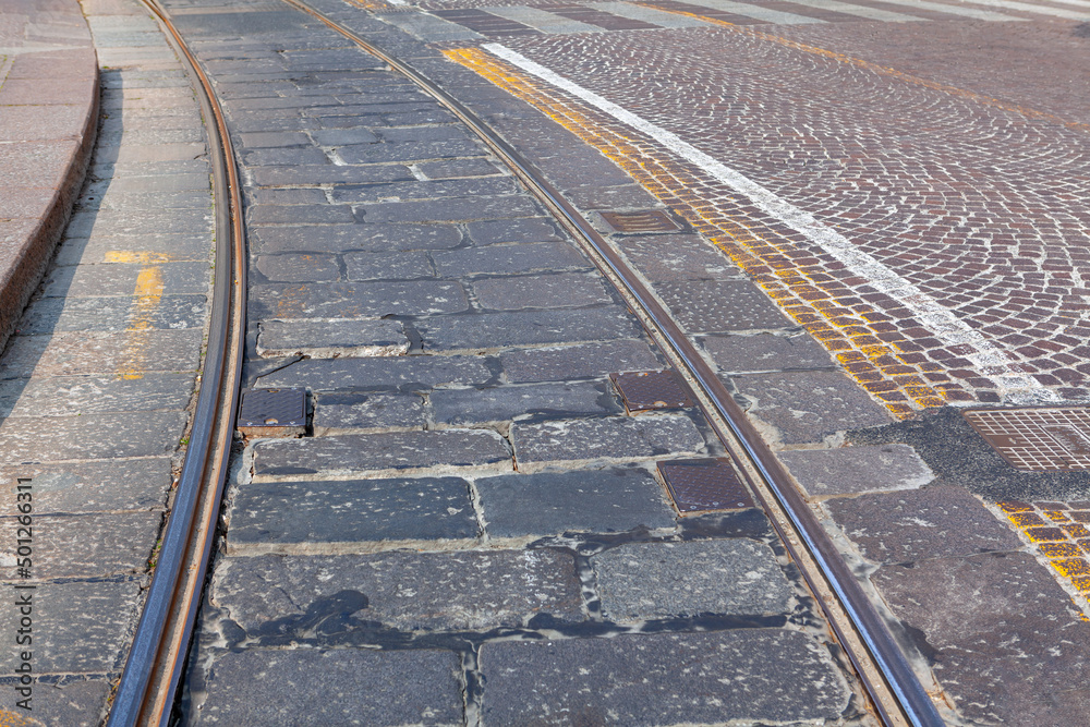 Tram rails and pavement in the city . Urban tram lines Tram rails and pavement in the city . Urban tram lines