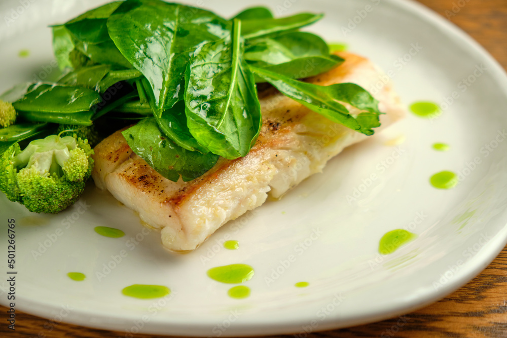 Pike perch fish fillet with spinach leaves Pike perch fish fillet with spinach leaves