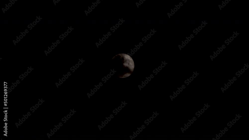 Dark Clouds Pass Over Moon In Black Sky. Locked Off Dark Clouds Pass Over Moon In Black Sky. Locked Off