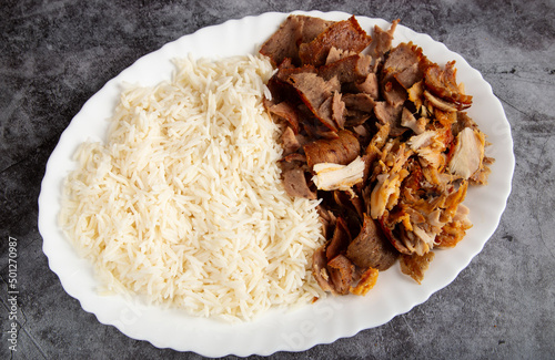 lamb kebab dish with basmati rice with sliced roast lamb meat.