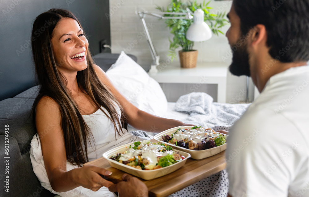 Men brings breakfast to bed for his beautiful girlfriend. Couple, love concept Men brings breakfast to bed for his beautiful girlfriend. Couple, love concept