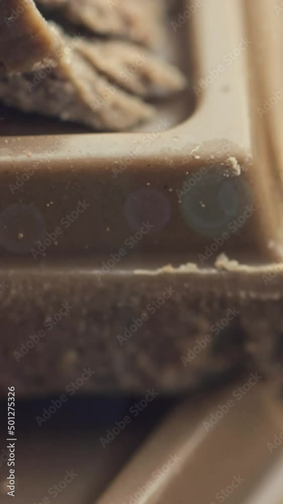 Animation of light over broken milk chocolate Animation of light over broken milk chocolate