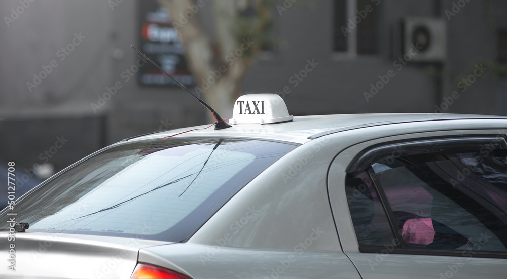 Taxi sign on car in the city.