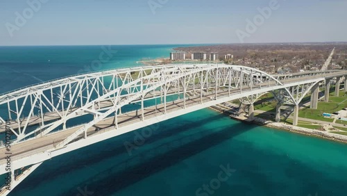 Blue Water Bridge connecting Port Huron, Michigan USA and Sarnia, Ontario Canada with drone moving down. photo