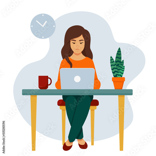 A girl with a laptop at the table