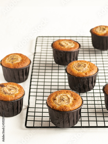 Banana cupcakes in the brown paper baking forms on the cooling rack