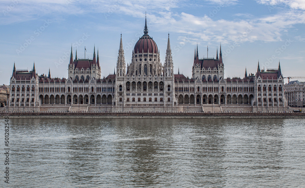 The Hungarian Parliament Building in the old town of Budapest, Hungary, Eastern Europe. Detail of the historical limestone facade and the towers of the iconic Hungarian landmark.