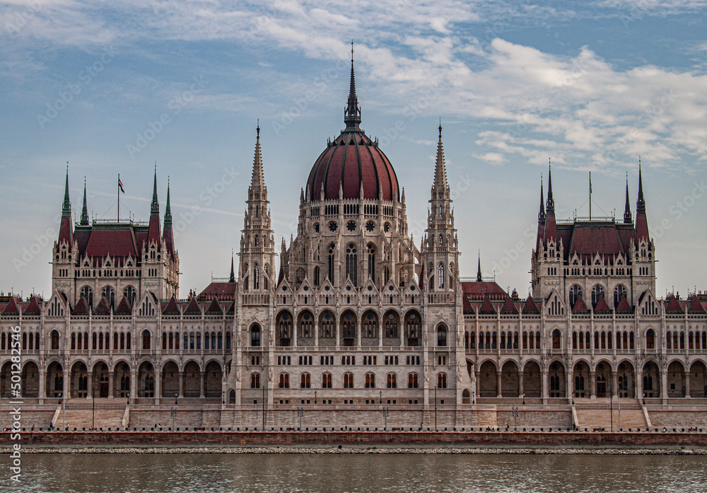 The Hungarian Parliament Building in the old town of Budapest, Hungary, Eastern Europe. Detail of the historical limestone facade and the towers of the iconic Hungarian landmark.